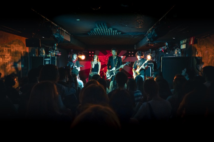 weyvir on stage with Hard Fuse in front of a packed room